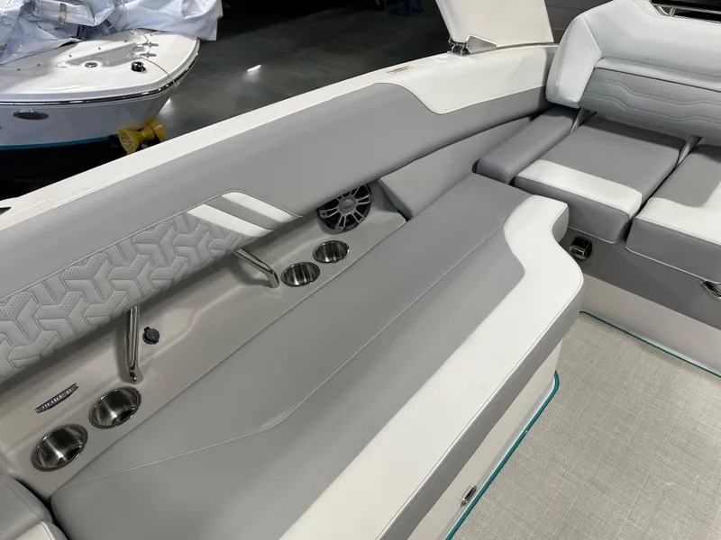 Slide: The Image of 2025 Regal LS6 boat interior with gray seating and cup holders. - 11