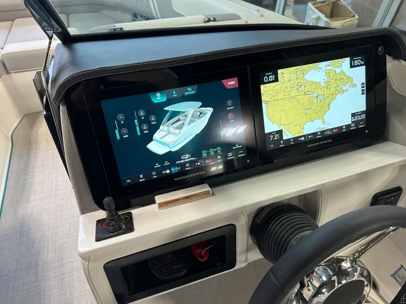 Slide: The Image of 2025 Regal LS6 dashboard with dual touchscreens displaying navigation and boat controls. - 14