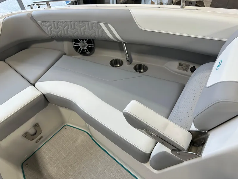 Slide: The Image of 2025 Regal LS6 boat interior with gray seating, cup holders, and speaker. - 19