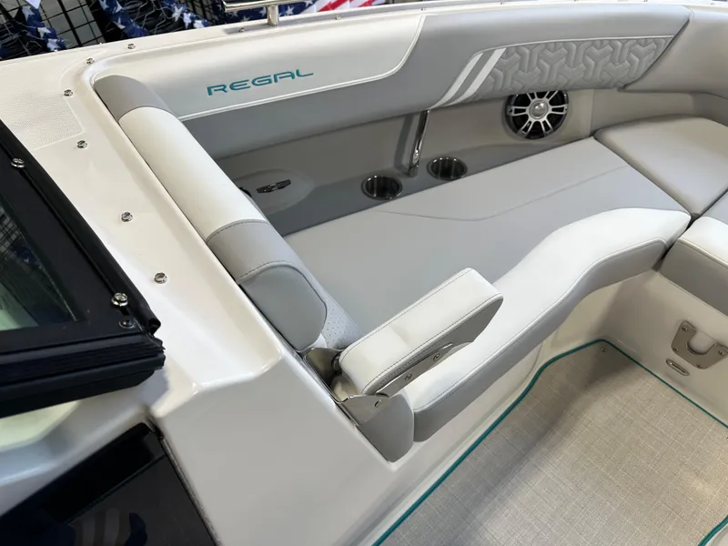 Slide: The Image of 2025 Regal LS6 boat interior with gray seating and speaker system. - 20