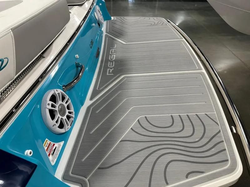 Slide: The Image of 2025 Regal LS6 boat swim platform with speaker and stylish design. - 5