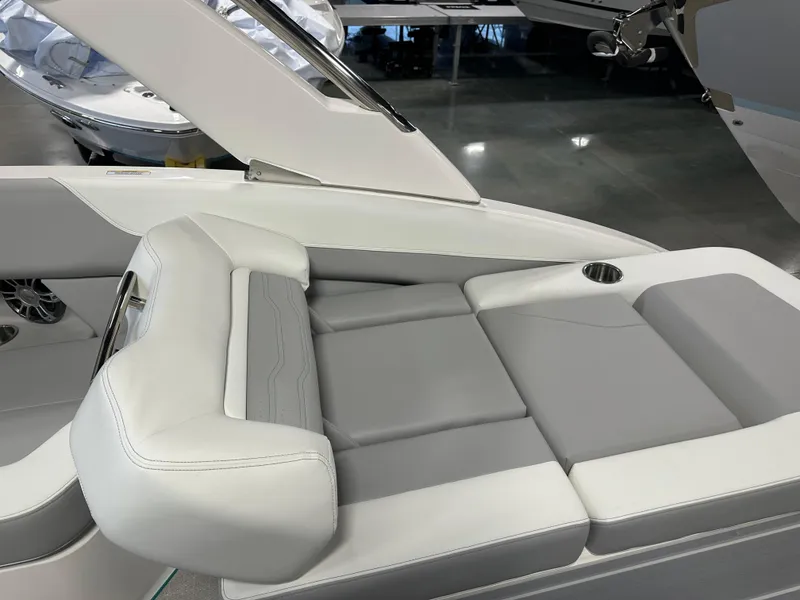 Slide: The Image of 2025 Regal LS6 boat interior with gray and white seating, cup holder, and sleek design. - 9