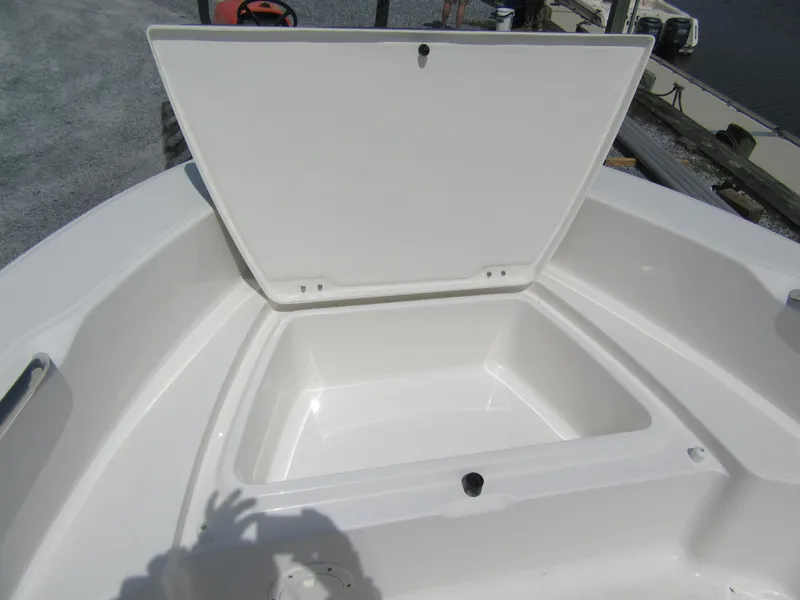 Slide: The Image of 2025 Robalo R160 Center Console boat storage compartment open, showcasing spacious interior. - 4