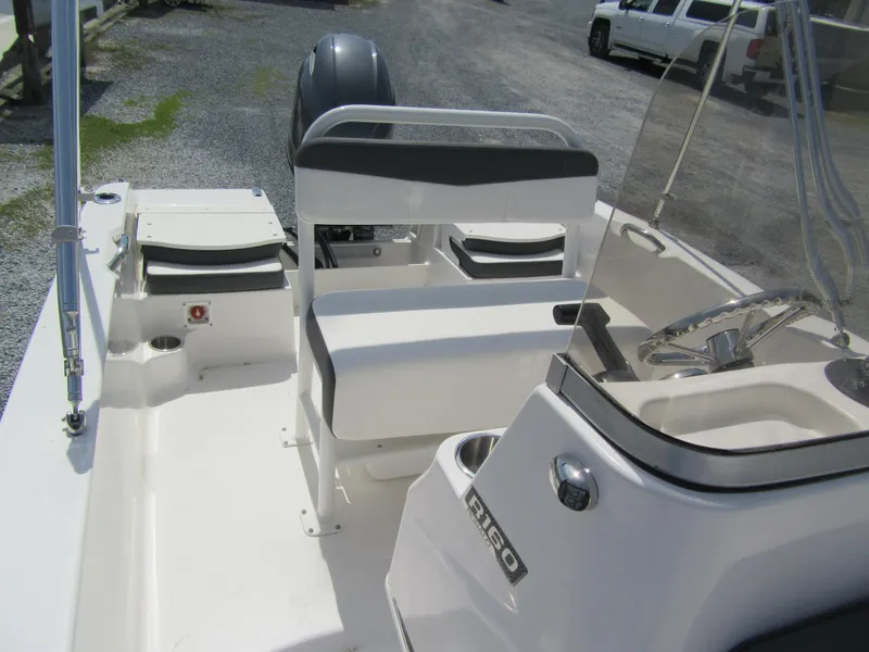 Slide: The Image of 2025 Robalo R160 Center Console boat interior with seating and steering wheel. - 6