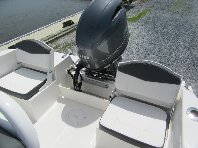 Slide: The Image of 2025 Robalo R160 Center Console boat with outboard motor and seating. - 7