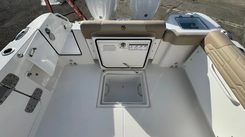 Slide: The Image of 2025 Edgewater 262CX boat interior with seating and storage compartments. - 12