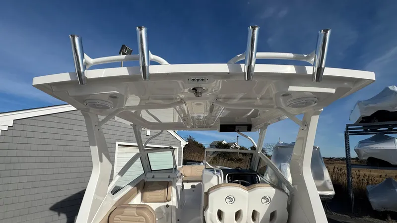 Slide: The Image of 2025 Edgewater 262CX boat with sleek design, spacious seating, and modern features under a clear blue sky. - 14