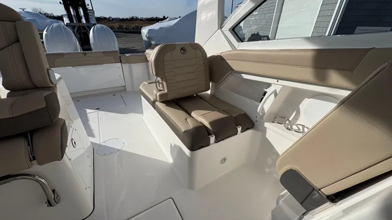 Slide: The Image of 2025 Edgewater 262CX boat interior with beige seating and modern design. - 17