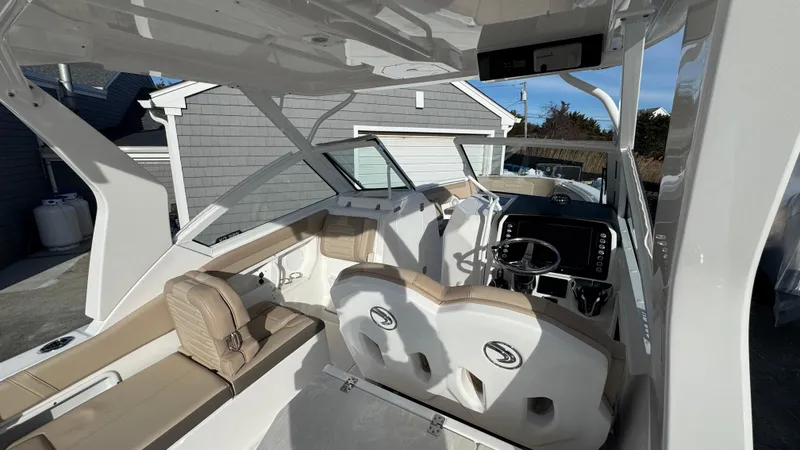 Slide: The Image of 2025 Edgewater 262CX boat interior with modern seating and dashboard. - 20