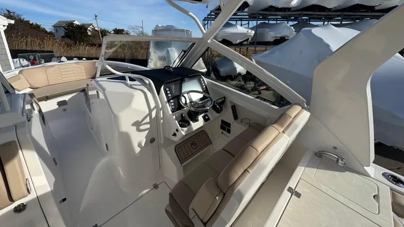 Slide: The Image of 2025 Edgewater 262CX boat interior with modern dashboard and seating. - 21