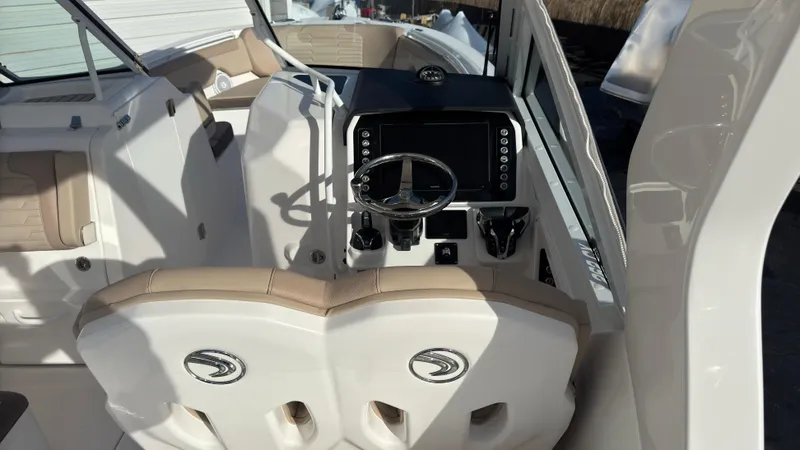 Slide: The Image of 2025 Edgewater 262CX boat interior with dual seats and modern dashboard. - 23