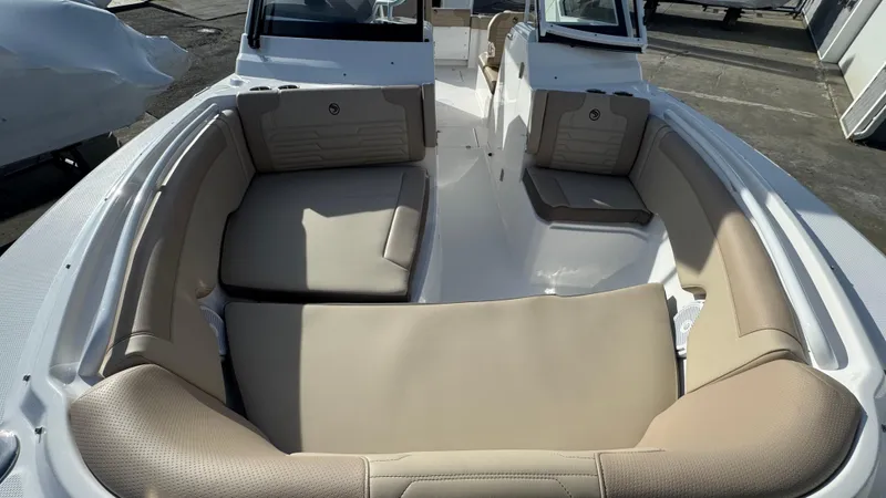 Slide: The Image of 2025 Edgewater 262CX boat interior with beige seating and spacious layout. - 30