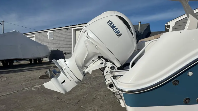 Slide: The Image of 2025 Edgewater 262CX boat with Yamaha outboard motor in a marina setting. - 9