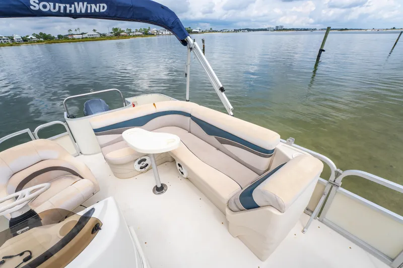 Slide: The Image of 2008 Bennington 201FS Southwind boat interior with seating and table on calm water. - 16