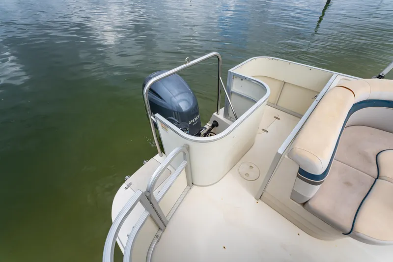 Slide: The Image of 2008 Bennington 201FS Southwind boat with outboard motor and seating area on calm water. - 19