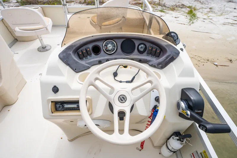 Slide: The Image of 2008 Bennington 201FS Southwind boat dashboard with steering wheel and controls. - 23