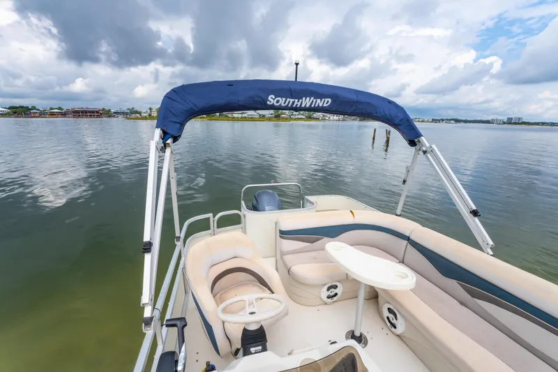 Slide: The Image of 2008 Bennington 201FS Southwind boat on calm water under cloudy sky. - 27