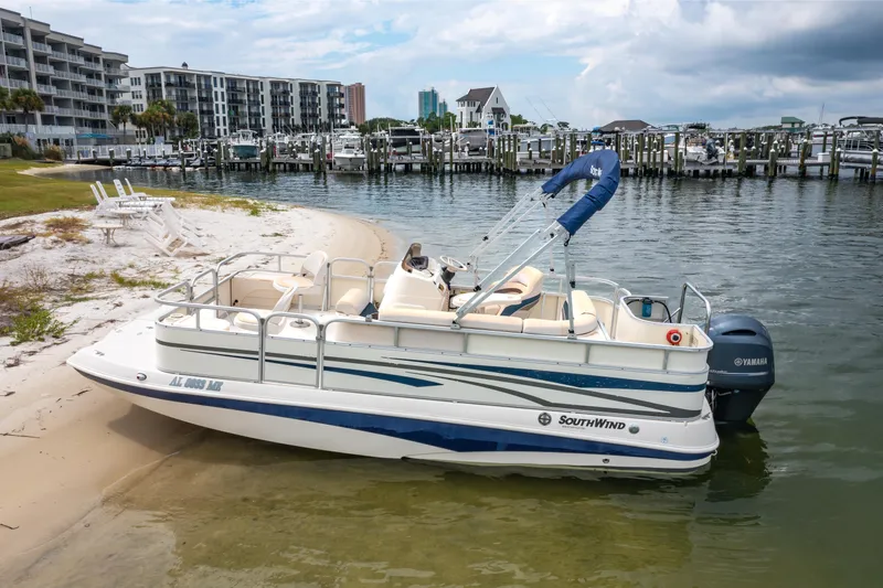 Slide: The Image of 2008 Bennington 201FS Southwind boat docked on sandy beach near marina. - 4