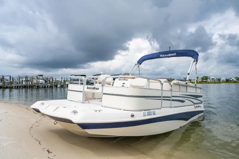 Slide: The Image of 2008 Bennington 201FS Southwind boat on sandy shore under cloudy sky. - 5