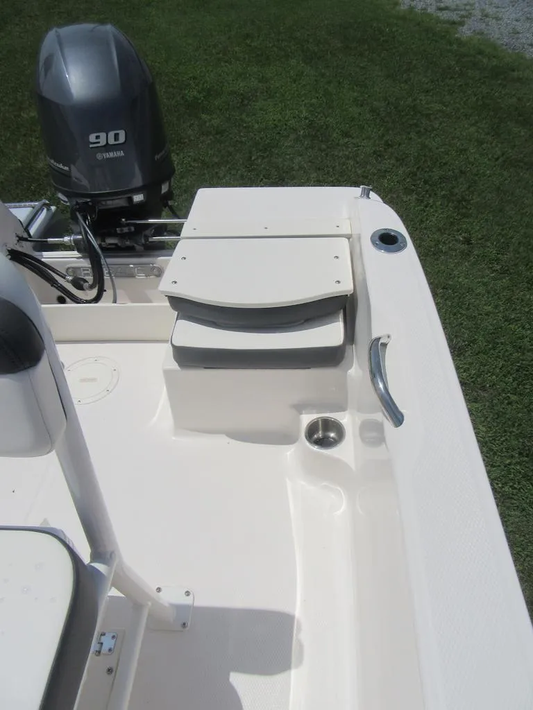 Slide: The Image of 2025 Robalo R160 Center Console boat with Yamaha 90 engine, white deck, and seating. - 11