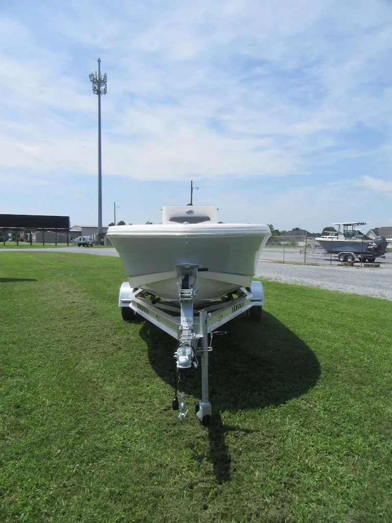 Slide: The Image of 2025 Robalo R160 Center Console boat on trailer, parked on grass under blue sky. - 3