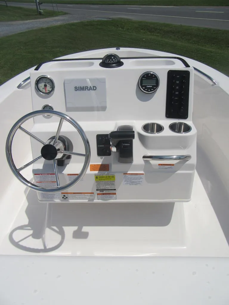 Slide: The Image of 2025 Robalo R160 Center Console dashboard with steering wheel and Simrad display. - 8