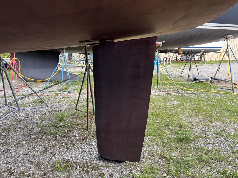 Slide: The Image of 2018 Beneteau Oceanis 45 sailboat keel on dry dock, supported by stands. - 19