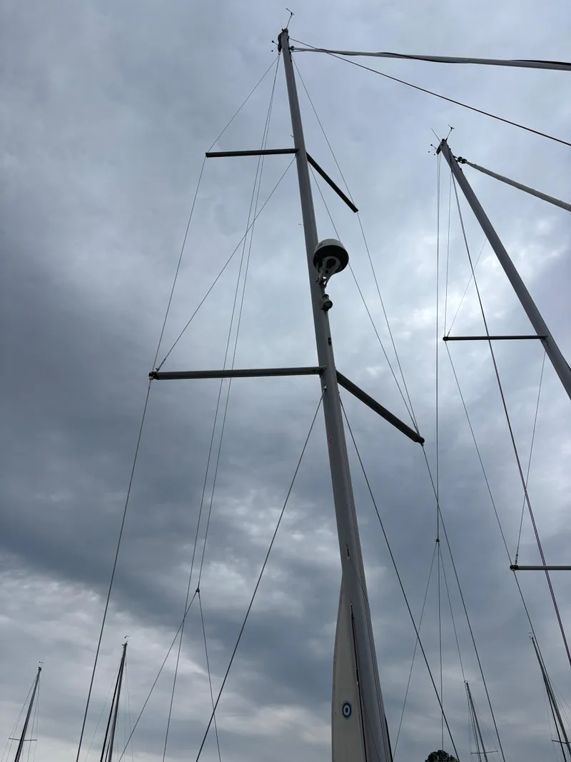 Slide: The Image of Tall mast of a 2018 Beneteau Oceanis 45 sailboat against cloudy sky. - 3