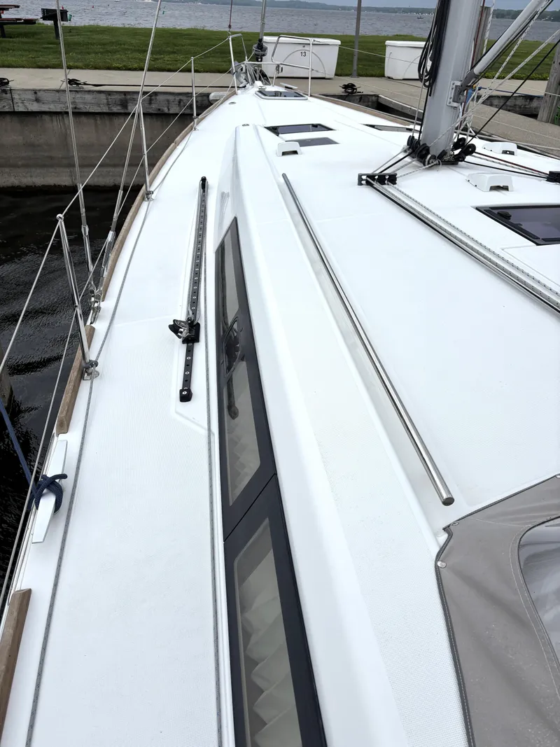 Slide: The Image of 2018 Beneteau Oceanis 45 sailboat deck, docked by the water. - 37