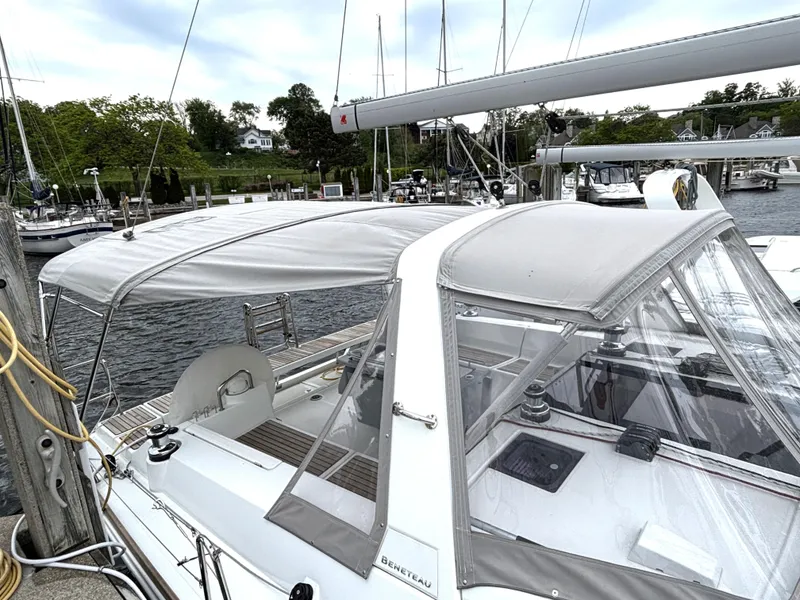 Slide: The Image of 2018 Beneteau Oceanis 45 sailboat docked, featuring a covered cockpit and sleek design. - 4
