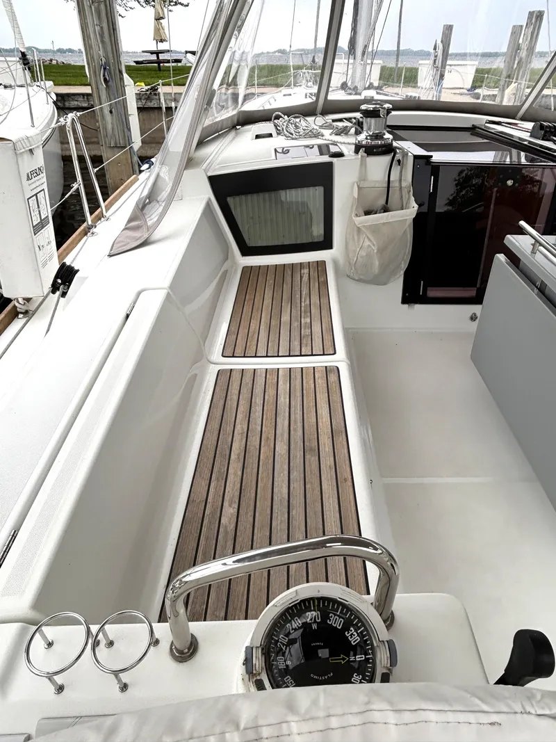 Slide: The Image of Cockpit of 2018 Beneteau Oceanis 45 sailboat with wooden flooring and navigation instruments. - 41