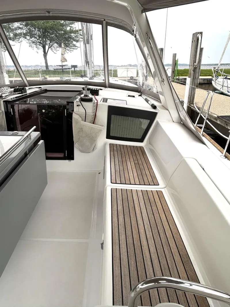 Slide: The Image of Interior view of 2018 Beneteau Oceanis 45 sailboat cockpit with wooden seating. - 42