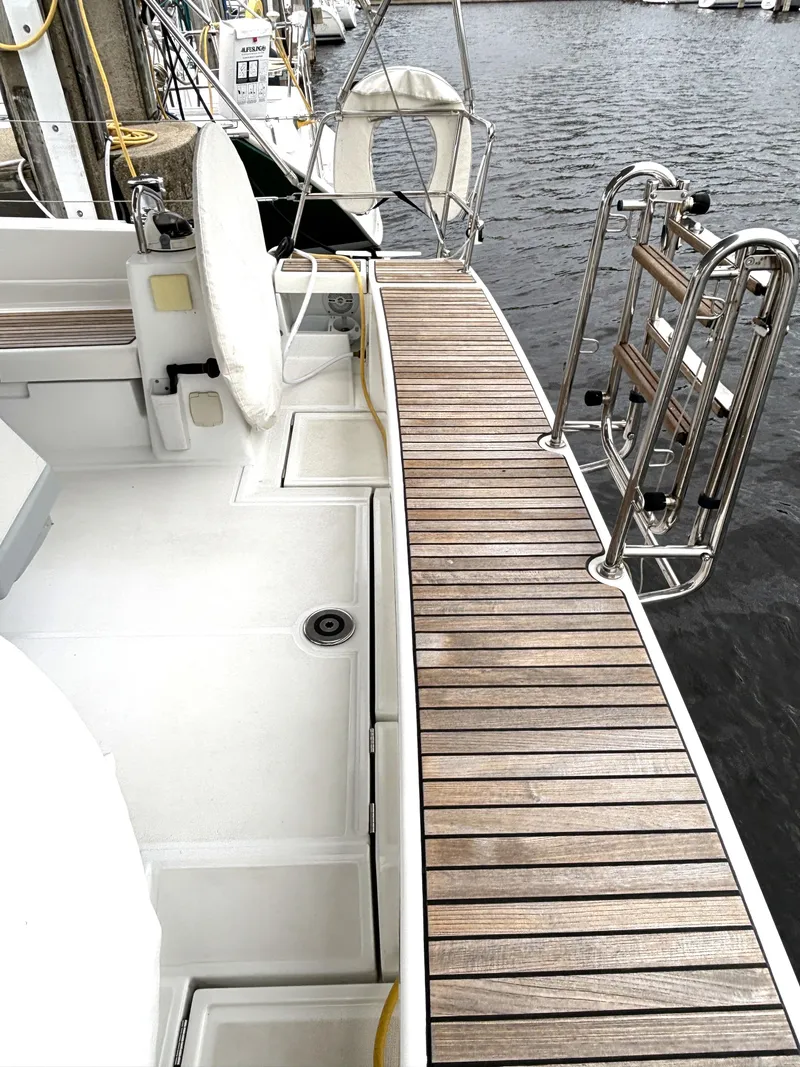 Slide: The Image of Beneteau Oceanis 45 yacht deck with wooden finish, docked at marina, 2018 model. - 43