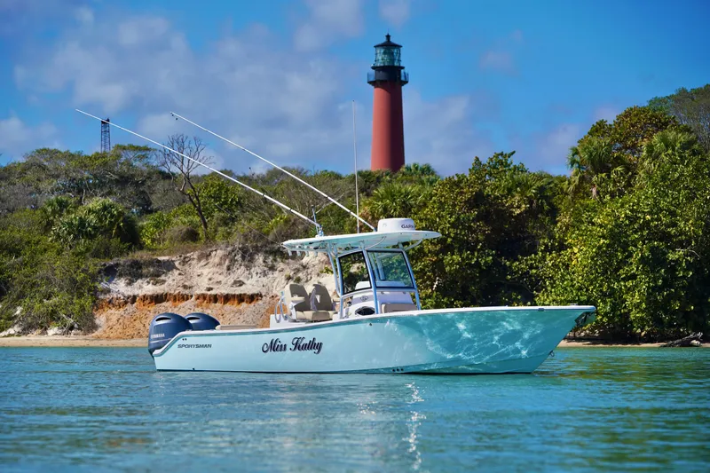 The Image of 2019 Sportsman Open 282 Center Console boat near lighthouse and lush shoreline. - 1
