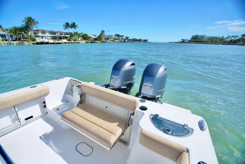 Slide: The Image of 2019 Sportsman Open 282 Center Console boat with twin engines on a sunny day. - 13