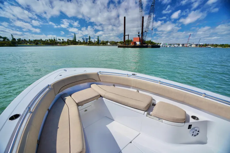 Slide: The Image of 2019 Sportsman Open 282 Center Console boat on calm water, featuring spacious seating. - 14