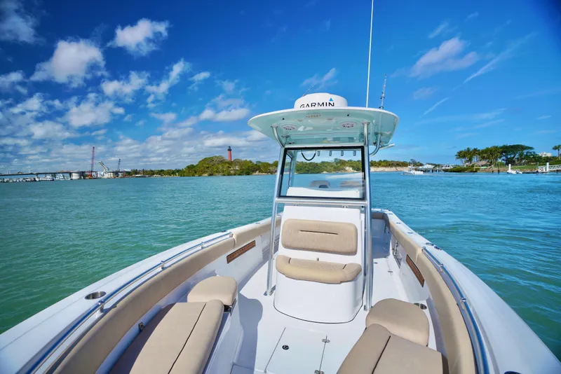 Slide: The Image of 2019 Sportsman Open 282 Center Console boat on clear blue water under a sunny sky. - 16