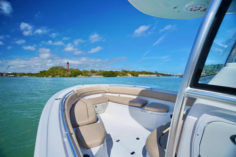 Slide: The Image of 2019 Sportsman Open 282 Center Console boat on clear blue water, scenic island view. - 4