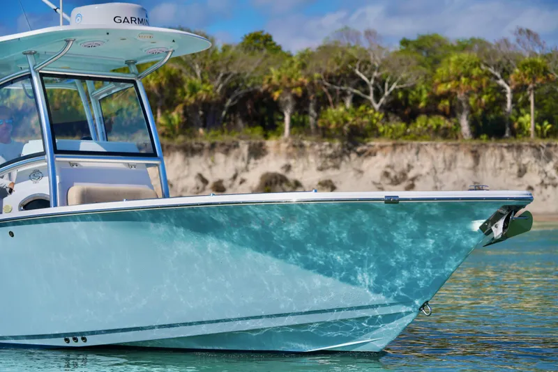 Slide: The Image of 2019 Sportsman Open 282 Center Console boat on calm water, with scenic background. - 6