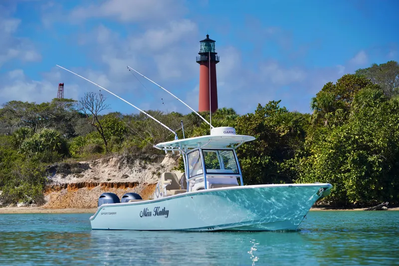 Slide: The Image of 2019 Sportsman Open 282 Center Console boat near a lighthouse, surrounded by lush greenery. - 7