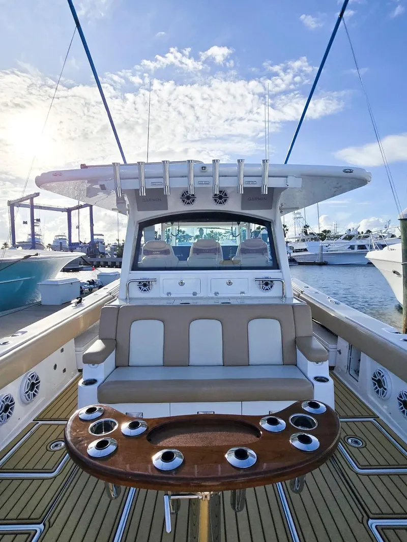Slide: The Image of 2023 HCB Suenos boat with spacious seating and modern design at a marina. - 15