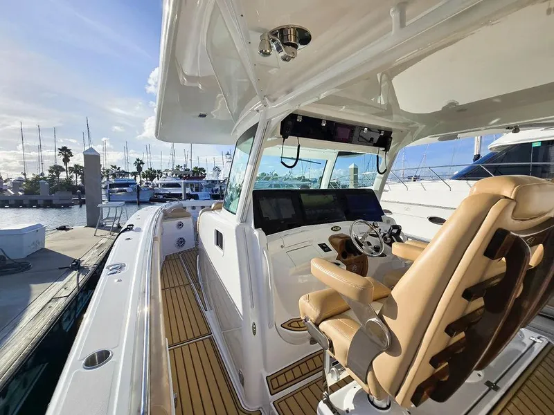 Slide: The Image of 2023 HCB Suenos boat controls with joystick and throttle on teak deck. - 32