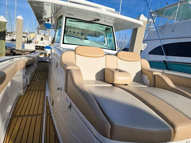Slide: The Image of 2023 HCB Suenos boat docked at marina, featuring spacious seating and elegant design. - 44