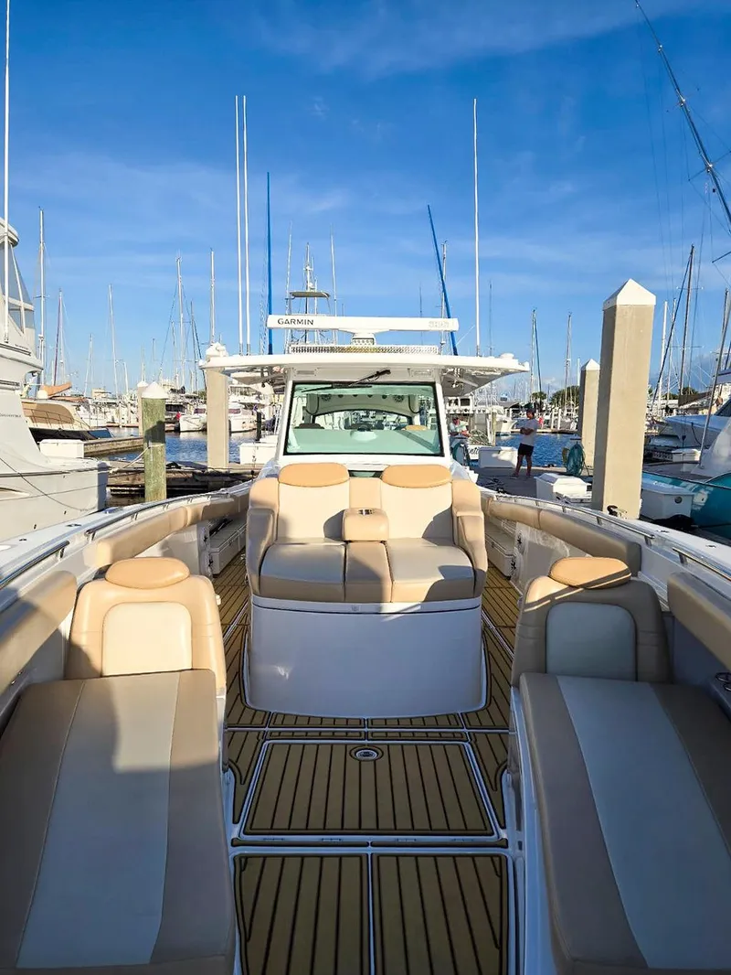 Slide: The Image of 2023 HCB Suenos luxury yacht docked in marina, featuring spacious deck and elegant design. - 47