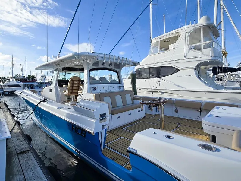 The Image of 2023 HCB Suenos boat docked in marina, featuring sleek design and spacious seating. - 0