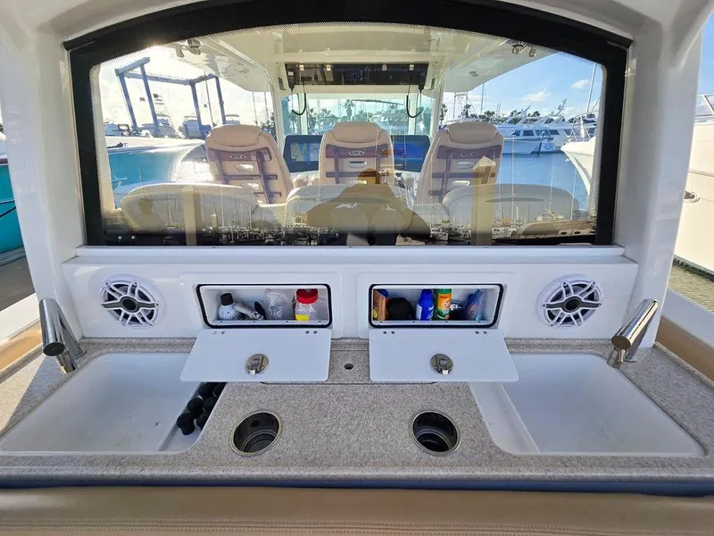 Slide: The Image of 2023 HCB Suenos boat interior with beige seating and advanced navigation system. - 20