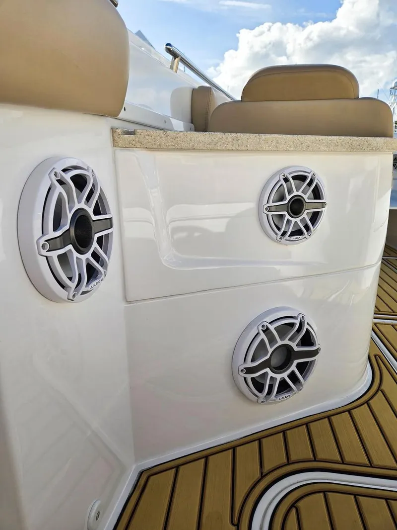 Slide: The Image of 2023 HCB Suenos boat deck with Frigid Rigid cooler and teak-style flooring. - 38