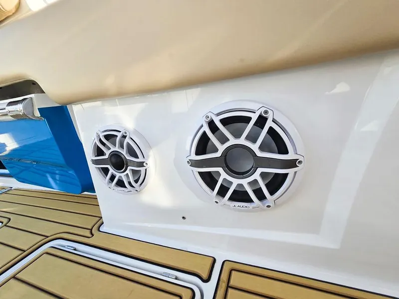 Slide: The Image of 2023 HCB Suenos boat interior with beige seating, wood flooring, and marina background. - 41
