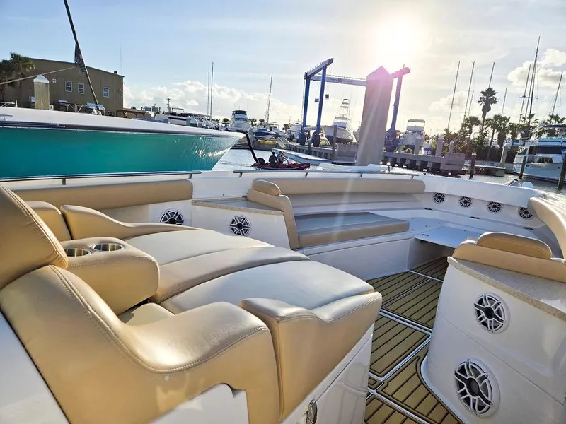 Slide: The Image of 2023 HCB Suenos boat with luxurious seating and sleek design at a marina. - 43