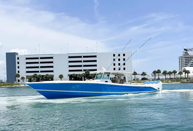 Slide: The Image of 2023 HCB Suenos boat cruising on water near modern buildings. - 5